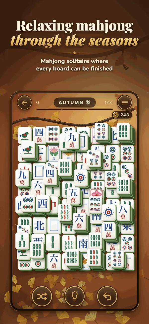 Seasons Mahjong: an autumn board among ginkgo leaves, with shuffle, hint and undo below